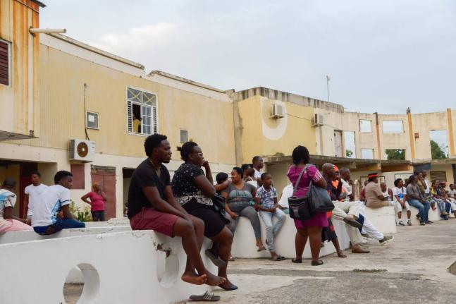 
Residents of Trench Town gather in the old Ambassador Theatre during a  community meeting.