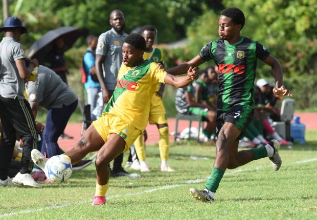 Shaquan Whyte (left) of Excelsior High, tries to pass the ball ahead of Calabar High’s Kimani Thompson  during their Manning Cup football match played at Calabar on Tuesday, October 13, 2026. Excelsior won the match 2-1.