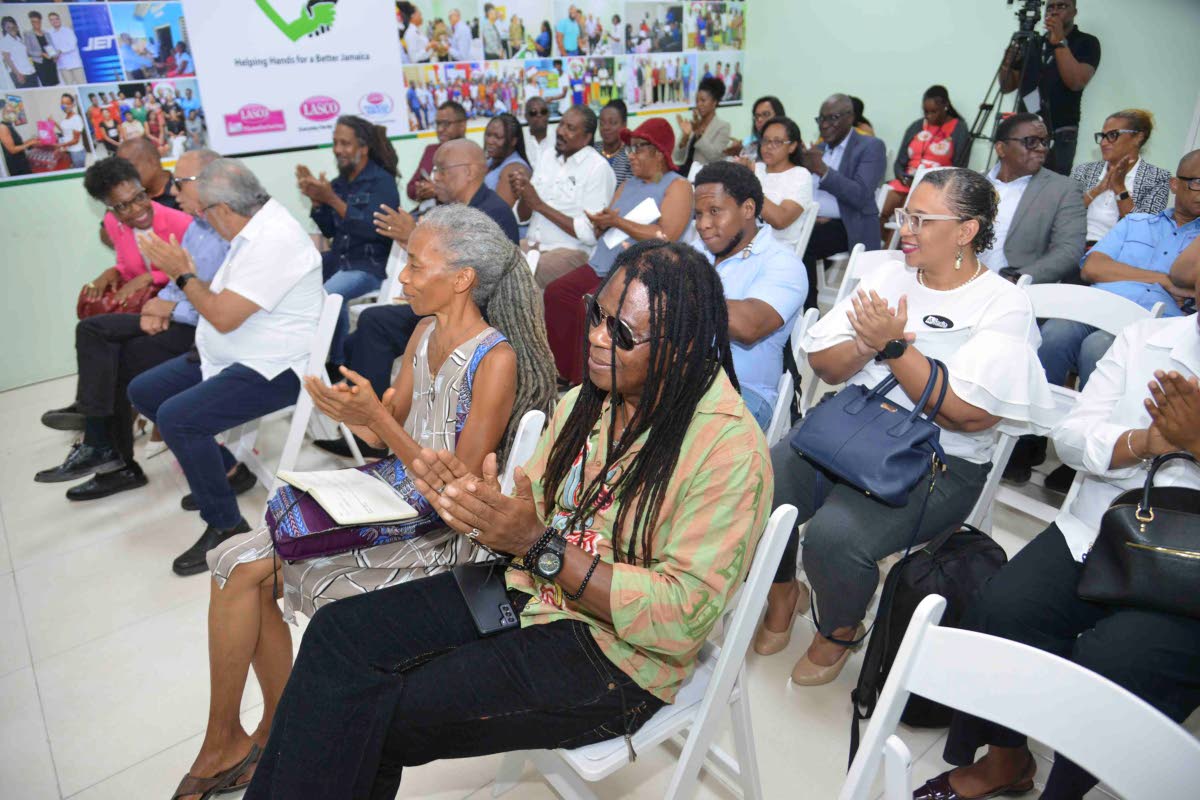 Invited guests applaud at the recent Lasco Chin Foundation press conference to unveil its Cultural Entrepreneurship Programme.