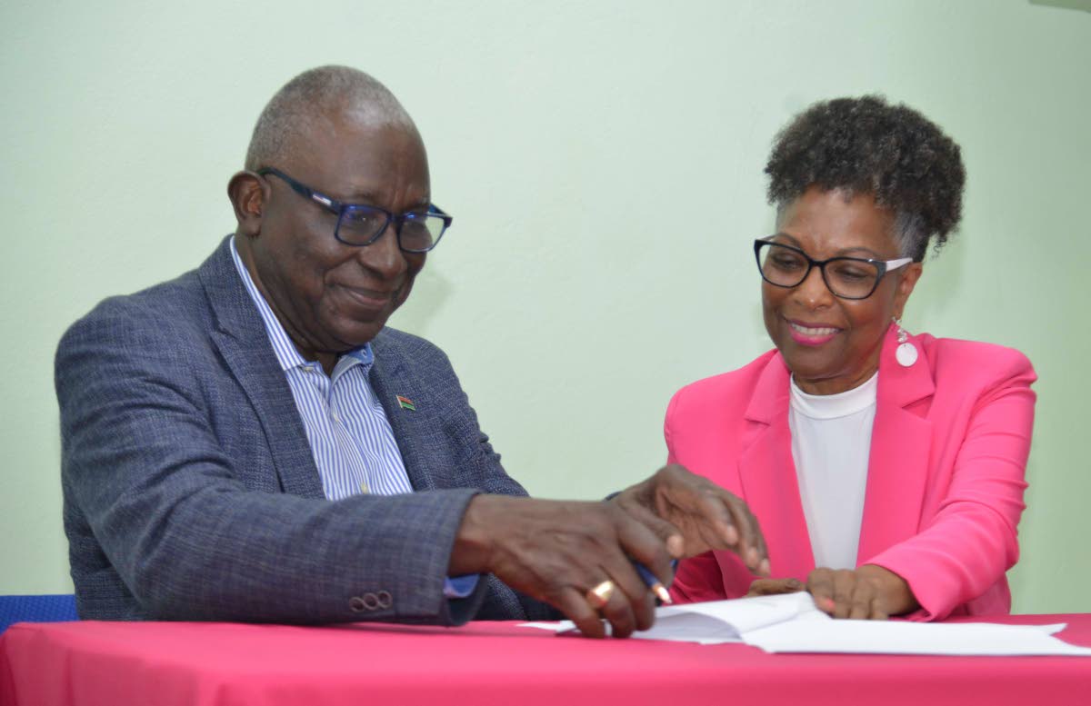 Major Retired Effiom Whyte. chairman of the Marcus Garvey in Schools Foundation, and Professor Rosalea Hamilton, chief executive officer, Lasco Chin Foundation, signing an agreement last Monday.