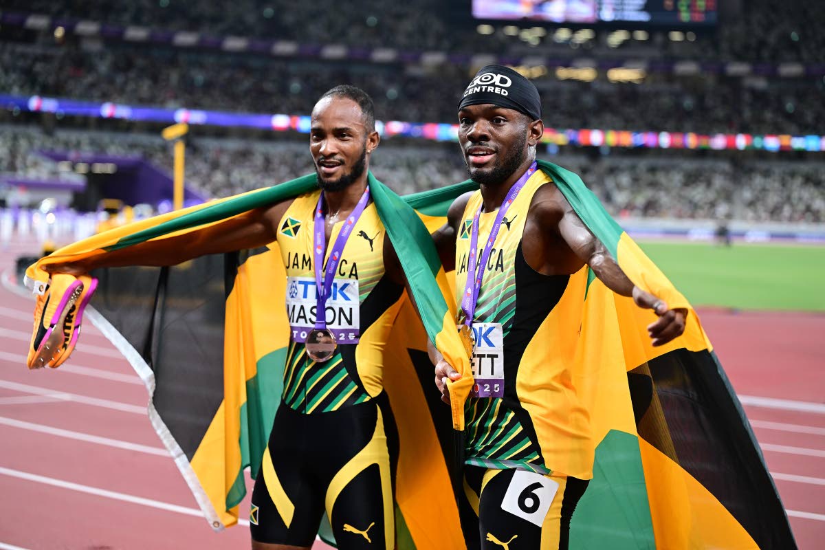 Medalists in the men’s 110m hurdles Orlando Bennett and Tyler Mason (right) celebrate second and third place respecively.