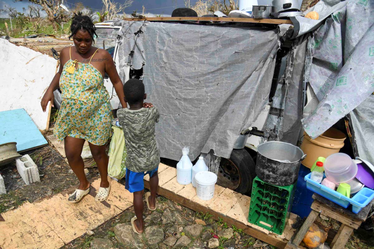 Crystal Morris and her son with some of their possessions outside the minivan they now call home in New Works, Westmoreland.