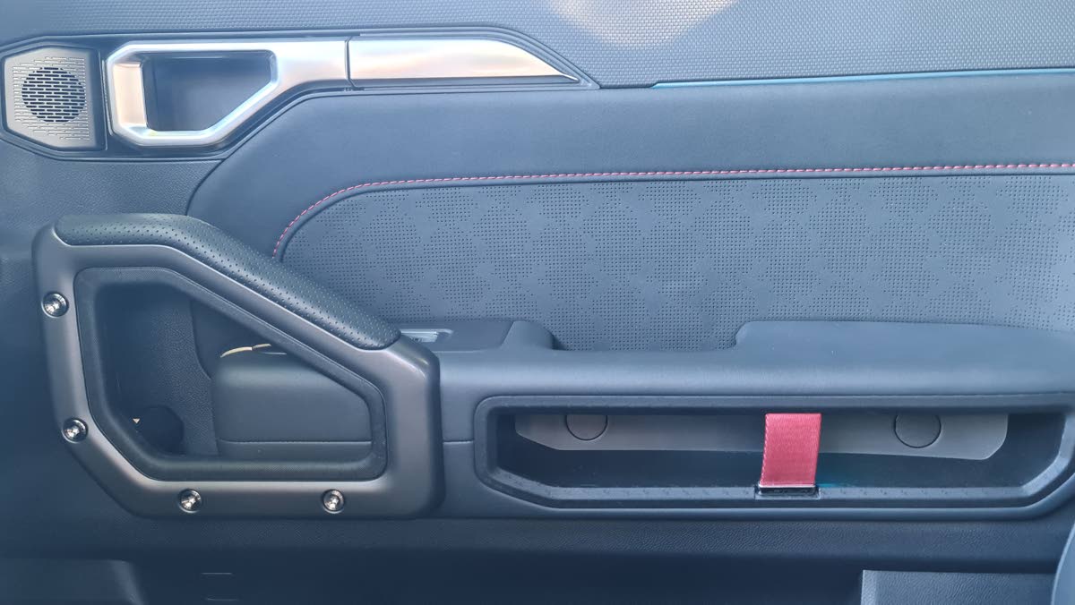 Close-up on the cabin’s meticulous design, showing the premium materials and integrated ambient lighting strip on the door panel.