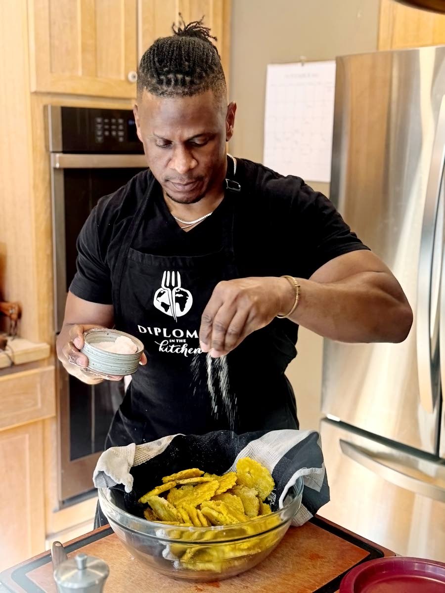 Knight, in the process of making tostones, also known as pressed plantains, during his book tour in Montana.