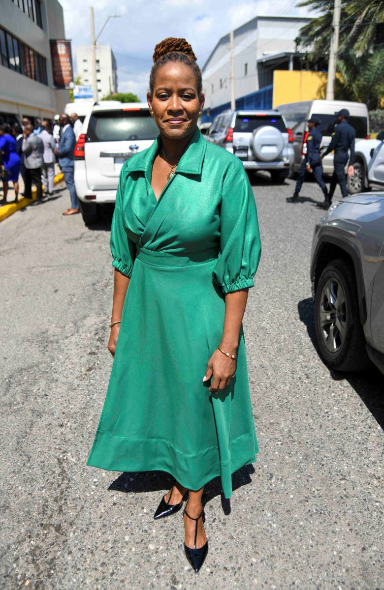 Senator Sherene Golding Campbell is poised in an elegant green midi dress from EtAl. 