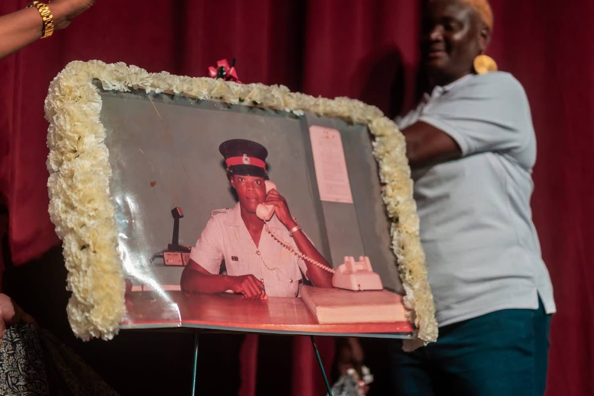 Portrait of Woman Constable Pamella Johnston being unveiled by sister Denise Johnston.