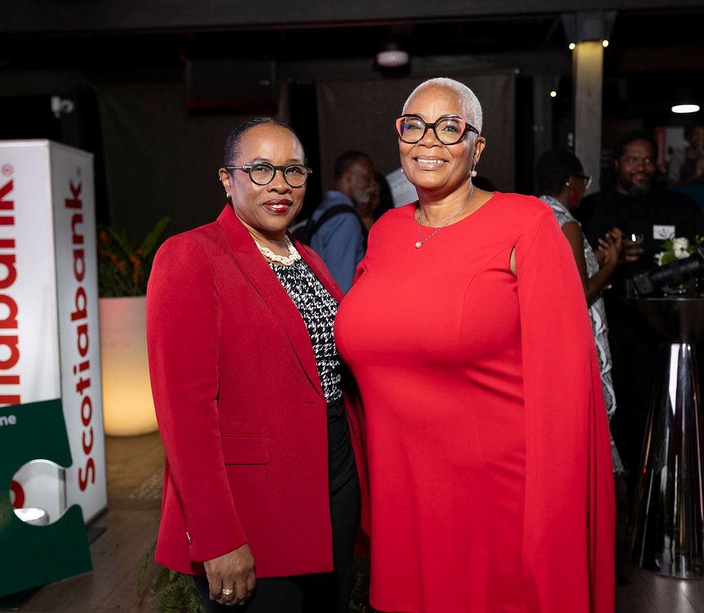 Ladies of Scotiabank, Yvett Anderson (left), head of retail banking, Caribbean North and Central, and Pam Douglas, senior manager, business banking, are adorned in shades of red. 