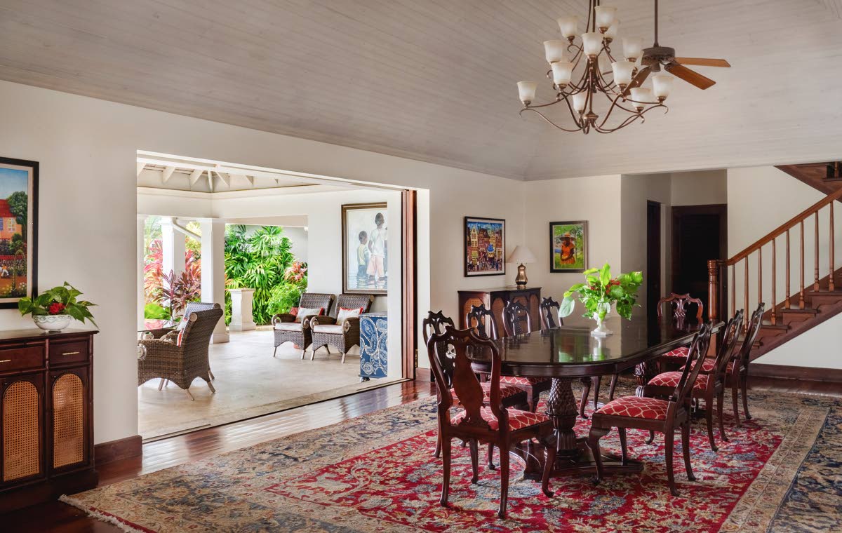The dining room opens wide to covered outdoor dining and living rooms.
