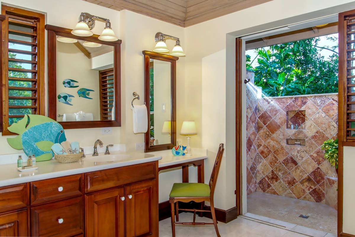 Bathrooms surprise with rarely seen indoor and outdoor showers in each. 