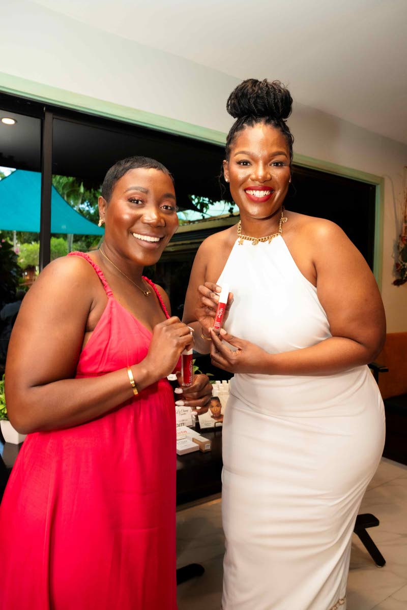  Girl bosses Keisha Bailey (left), of Bailey Wealth Group, and Shanique Ellington, of Le Champ Cosmetics, are all smiles as they show off their favourite lippies.