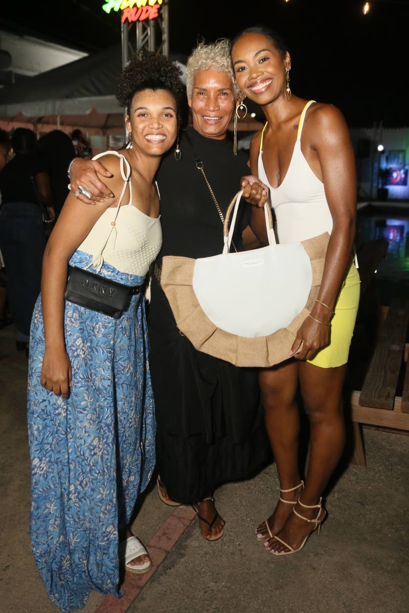 Bridget Sandals Founder Bridget Brown (centre) shares a moment with fashion designer Ackeilia Caine (left) of Trendzy by Ackeilia and model Latoya Spence as they discuss handbag designs by Yellow Room Studio, created by Spence.
