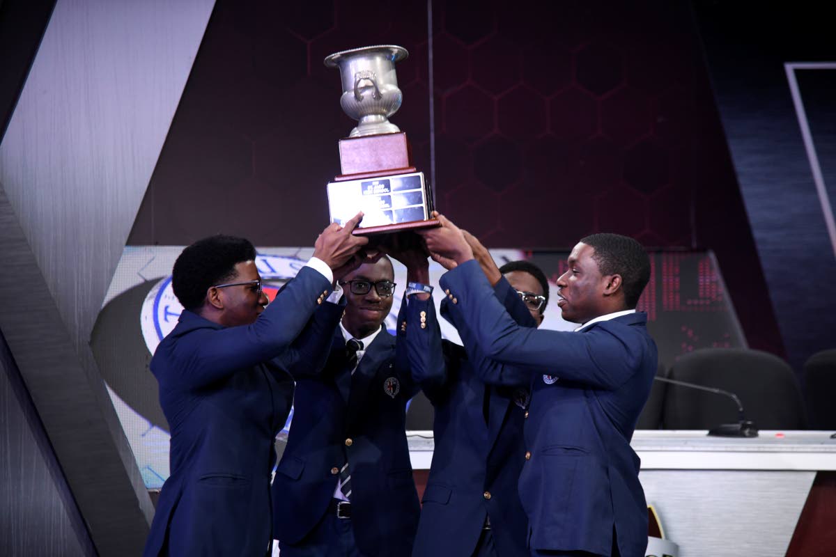 Members of the Jamaica College team celebrate with the Schools’ Challenge Quiz championship trophy after their victory during the grand finale of the 2026 competition on Thursday night at TVJ’s studios in St Andrew. 