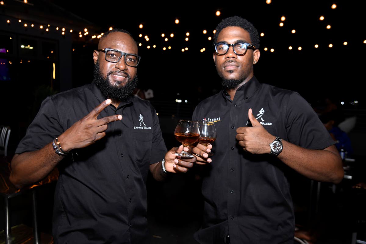 Andre Miller (left), operations manager at Di Ferrano, and Justin Fearon, co-managing director, raise glasses at the launch of Di Ferrano on Wednesday at Big Buy Plaza in Portmore, St Catherine.