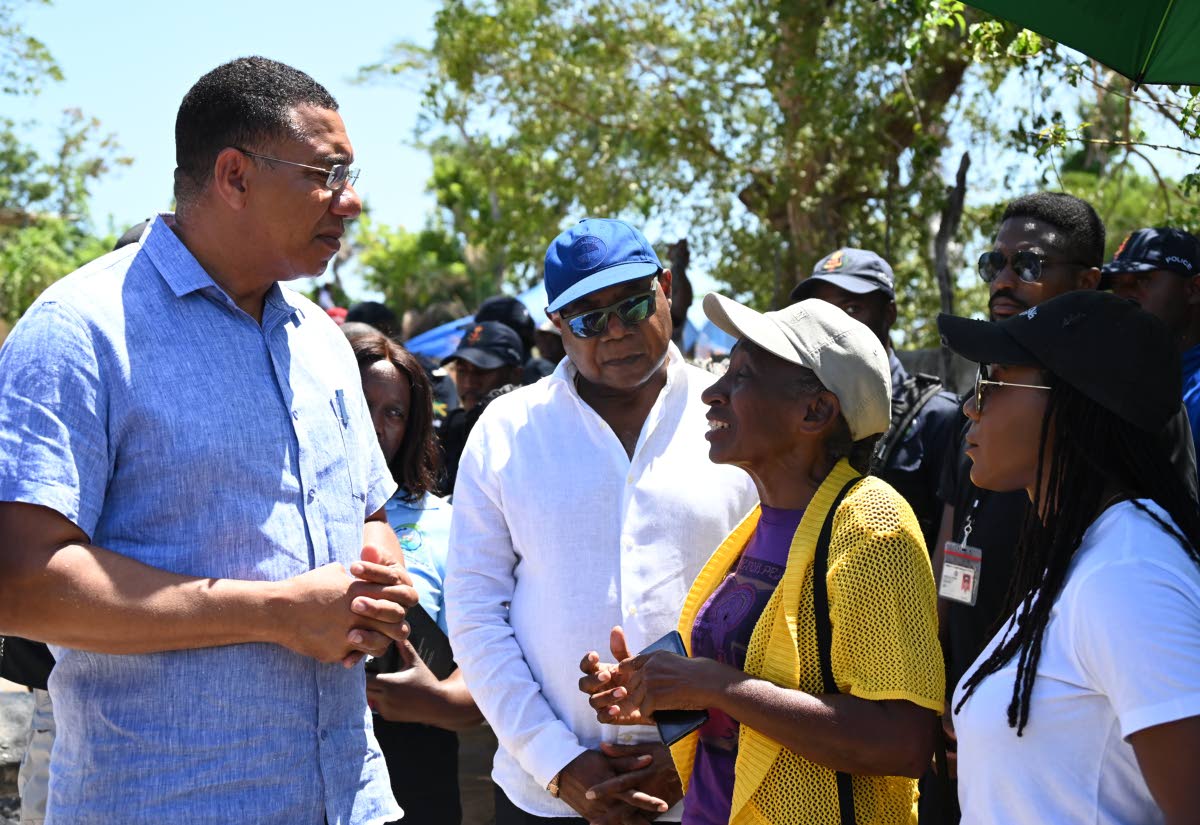 From left: Prime Minister Dr Andrew Holness in conversation with Edmund Barlett, member of parliament (MP) for St James East Central; Debbie Lewis, resident; and Tova Hamilton, MP for Trelawny North, during a tour of Coopers Pen in Trelawny yesterday.