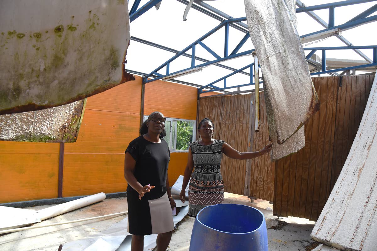 Tanshea Williams-Johnson (left), Vice Principal, St Mary Technical High school, Marvalee Tomlinson-Russell (right), head of the 6th Form Department, inspects the 6th form block that was damaged during the passage of Hurricane Melissa on October 28, 2025.