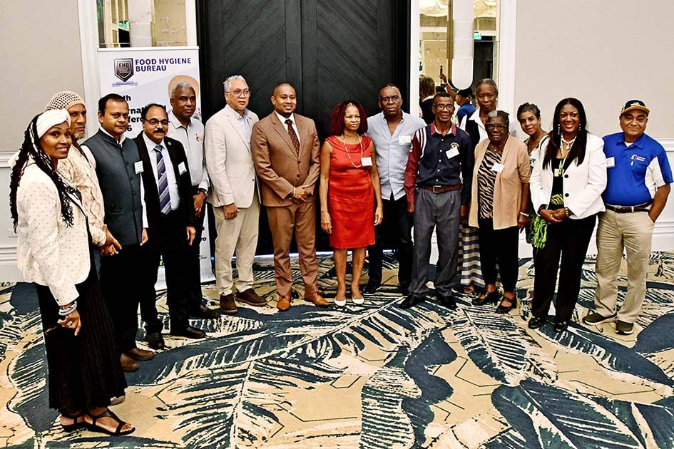 Agriculture Minister Floyd Green (centre) poses with Food Hygiene Bureau CEO Dr Marva Hewitt and participants on the opening day of the FHB 2026 Conference. 