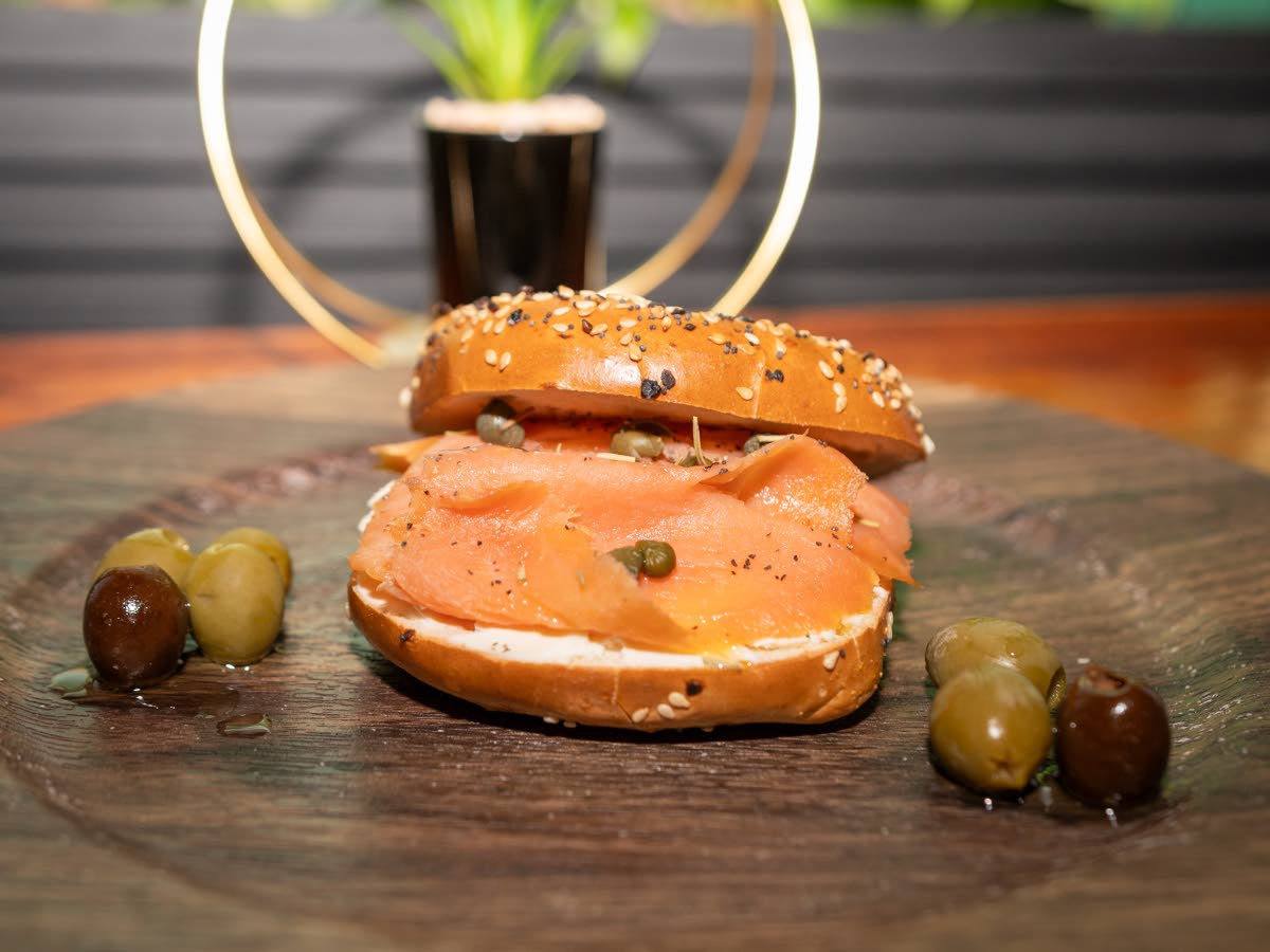 Fresh baked bagel bun, with a thick layer of smooth herbed cream cheese, smoked salmon and a drizzle of olive oil.