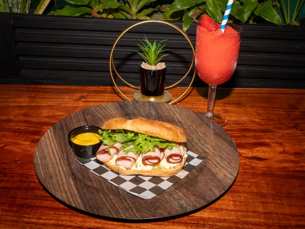 Jerk chicken breast sandwich, with cream honey mustard and layered with lettuce, tomatoes and mozzarella cheese.