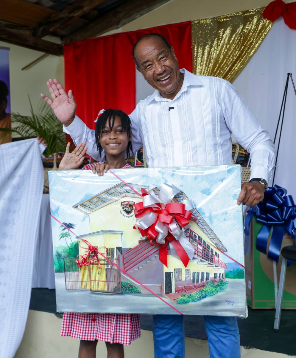 Annaleah Russell, a Grade 6 student at Santa Cruz Preparatory School, presents NCB Financial Group Chairman Michael Lee-Chin with a painting of the institution during a recent event marking the N.C.B. Foundation’s support for post-Hurricane Melissa repai