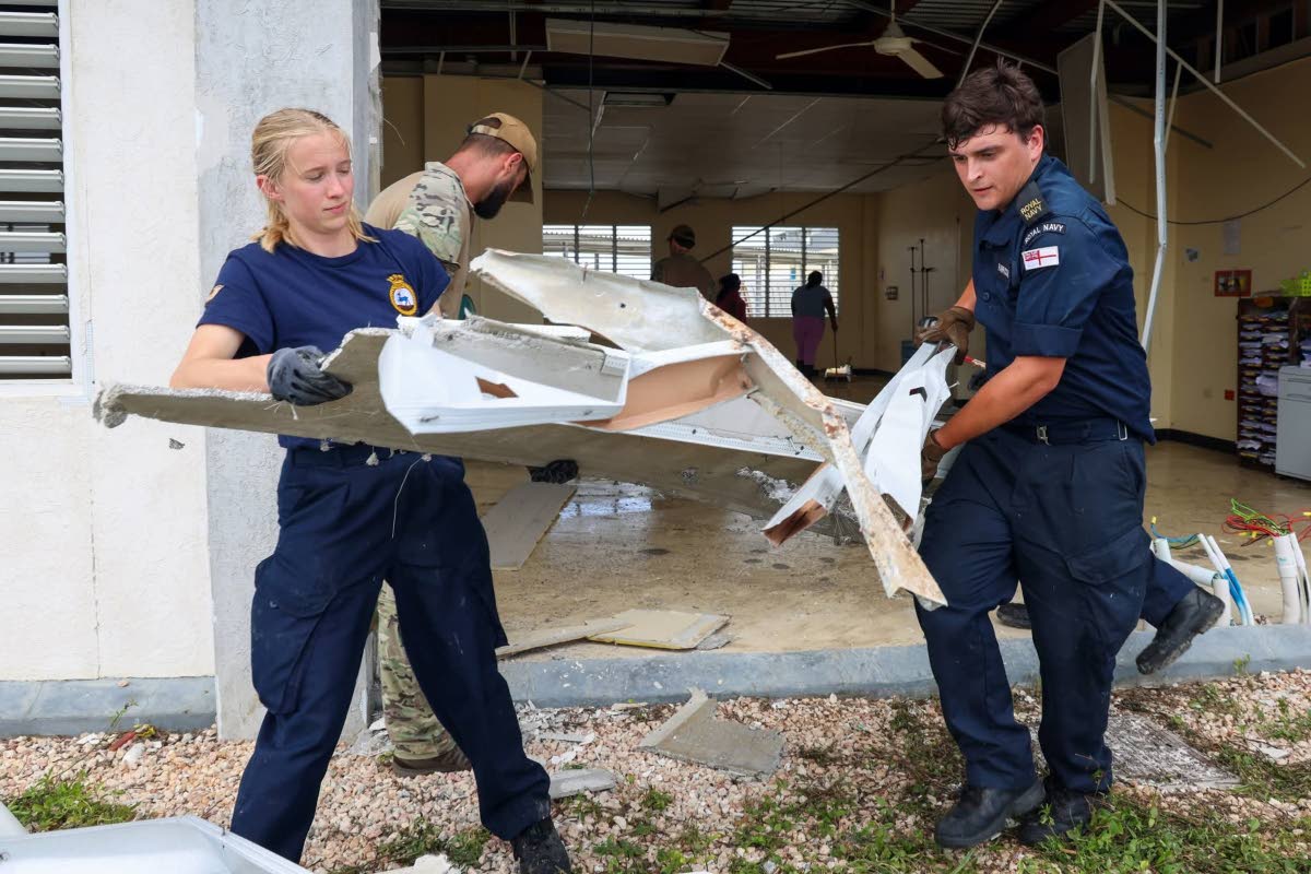 
Specialist personnel from the UK’s Royal Navy ‘HMS Trent’ assisting hospital workers at the Falmouth Hospital in Trelawny after Hurricane Melissa.