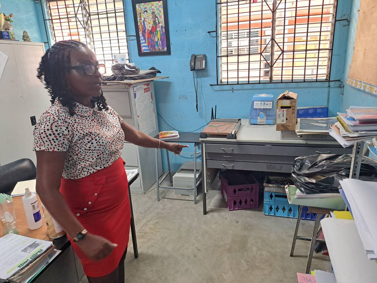 Nicola Morris, head of the visual arts and music department at Herbert Morrison Technical High School in St James, shows sections of the department's office that sustained flood damage during the passage of Hurricane Melissa.
