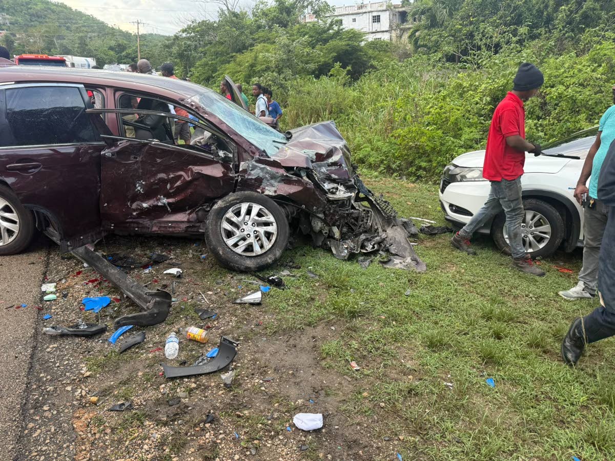 Onlookers gather at the scene of a motor vehicle crash involving a burgundy Honda CR-V, in which Jamaica Teachers' Association president-elect Dr Maureen Mullings-Nelson was a passenger, and a white Honda CR-V, near Duncans, Trelawny on October 1, 2026.