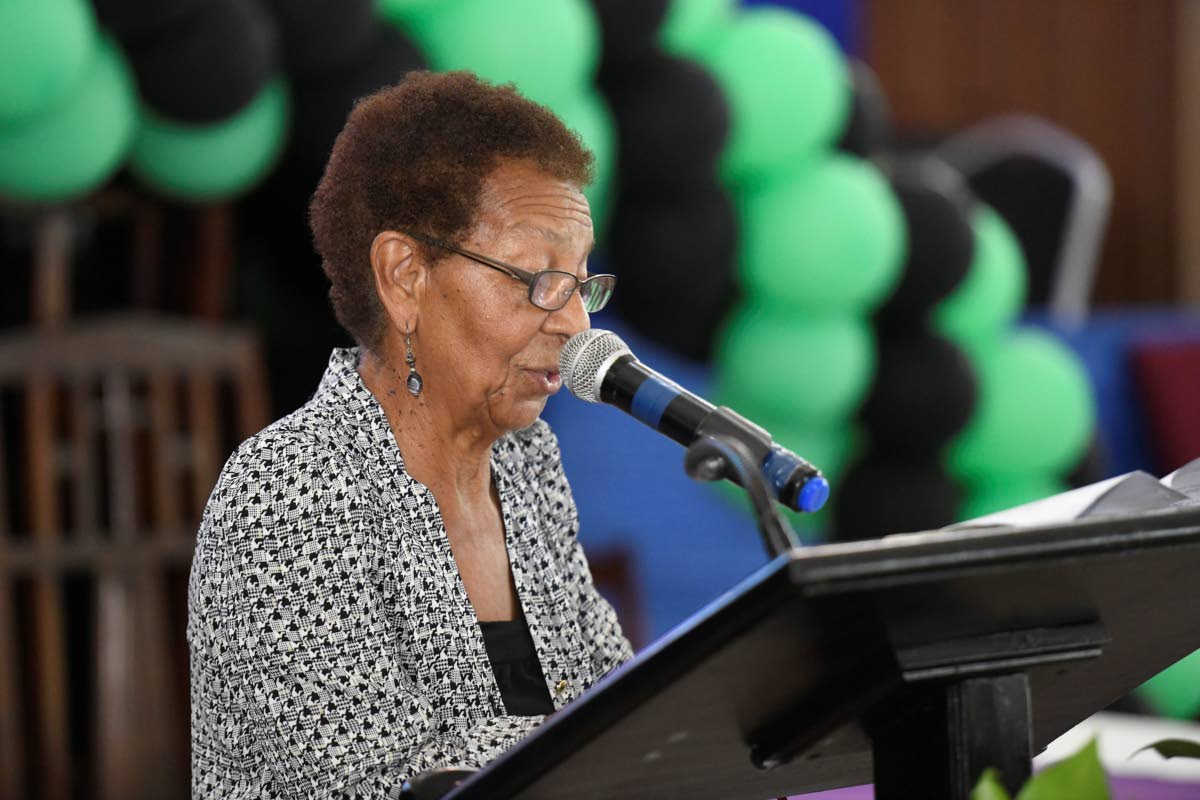 Norma Brown-Bell reads the eulogy at the funeral for veteran broadcaster Dervan Malcolm.