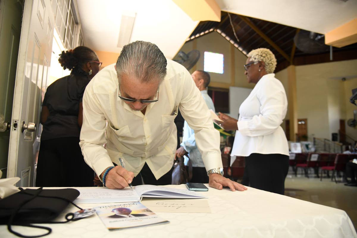 President of the Senate Tom Tavares Finson signs the condolence book for late veteran journalist Balford Henry