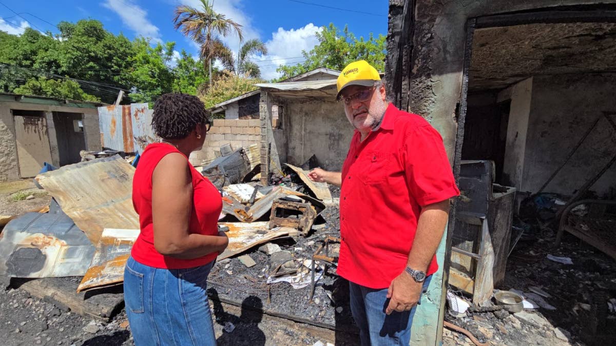 Opposition Leader Mark Golding (right) and St Andrew South West Member of Parliament Dr Angela Brown Burke on a tour of Kidd Lane off Spanish Town Road, St Andrew, on Monday. 