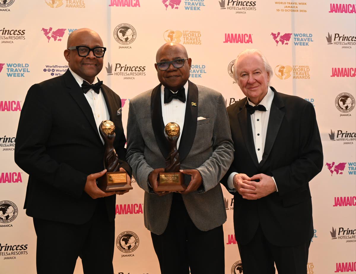 From left: Director of Tourism Donovan White and Minister of Tourism Edmund Bartlett hold two of Jamaica’s seven awards as they pose or a photo with Graham Cooke, founder and president of the World Travel Awards, at the Princess Grand in Hanover on Sunda