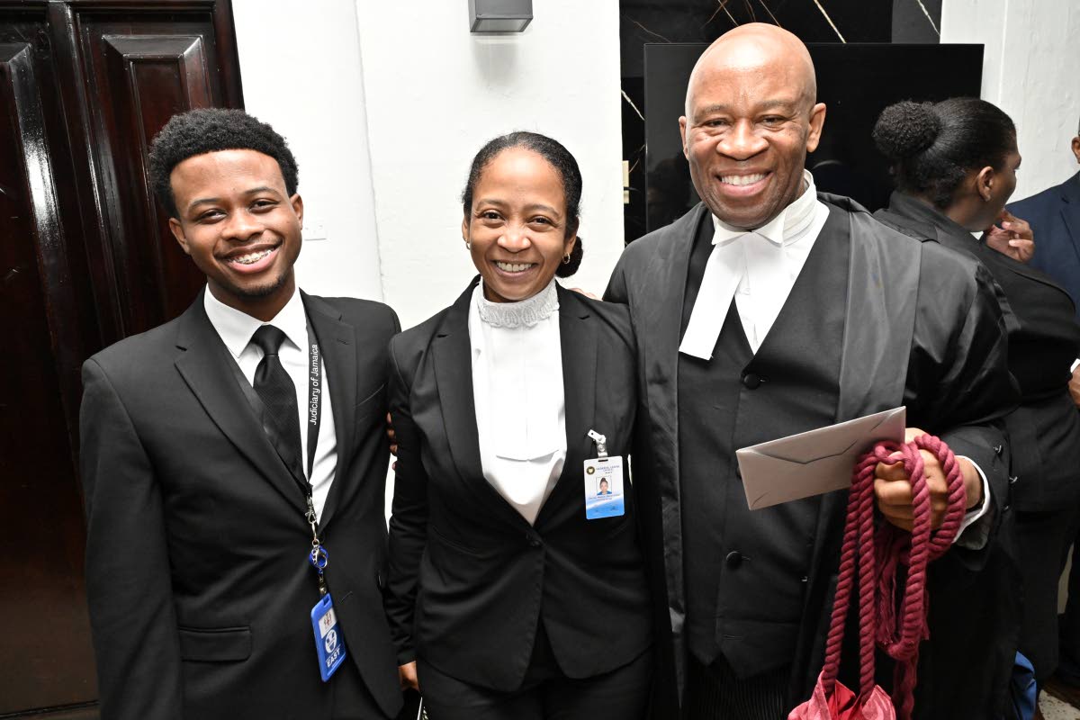 Oswest Senior-Smith, KC (right) is greeted by his wife Denise Senior-Smith and son Romano after his admission to the Inner Bar on Tuesday.