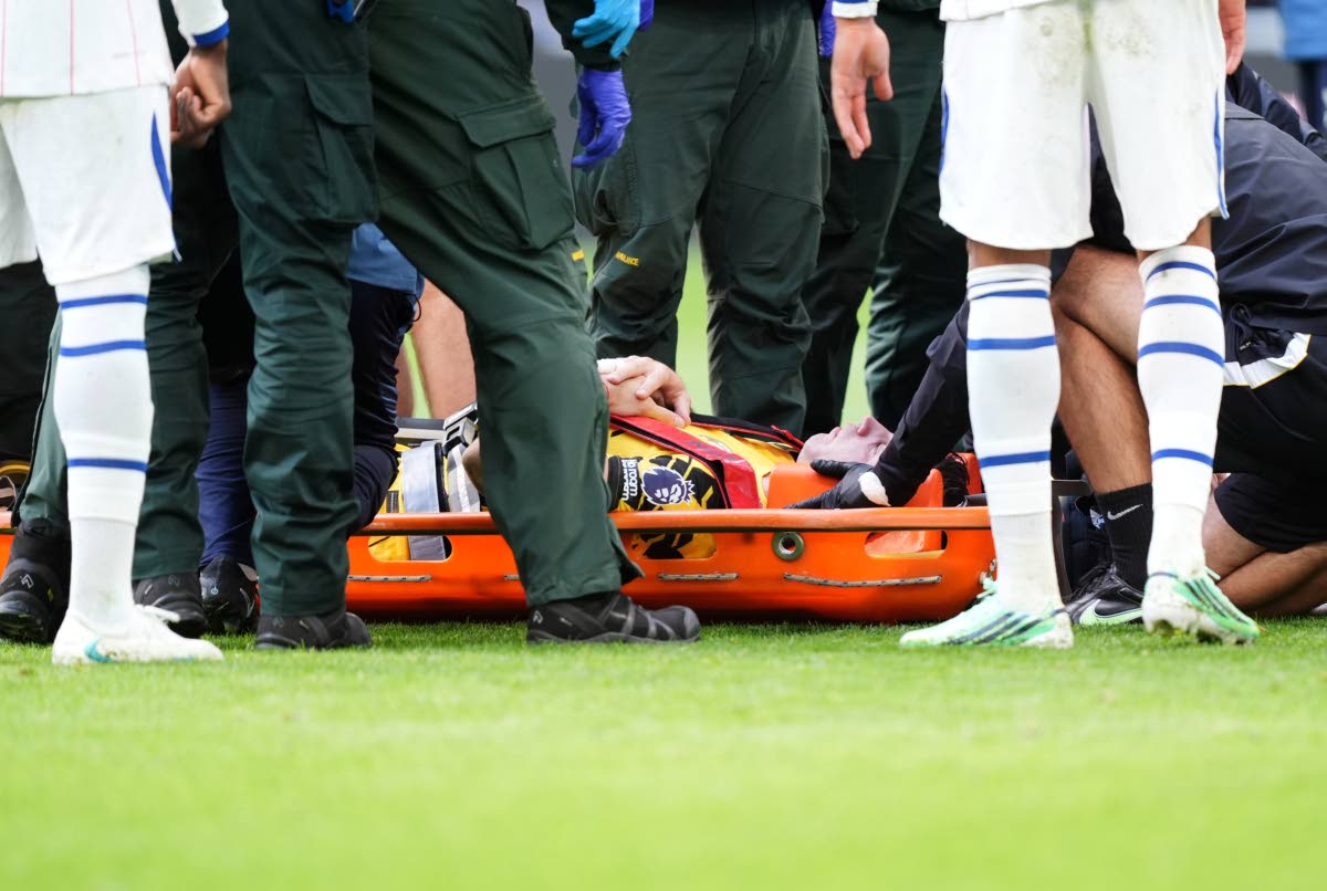 Chelsea goalkeeper Emiliano Martinez is carried off the pitch on a stretcher after incurring an injury during the English Premier League soccer match between Everton and Chelsea in Liverpool, England, Saturday, Oct. 17, 2026. (Mike Egerton/PA via AP)