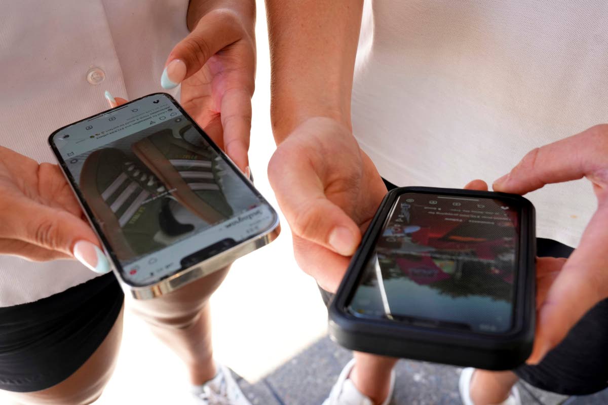 Young people use their phones to view social media in Sydney on Nov. 8, 2024. 