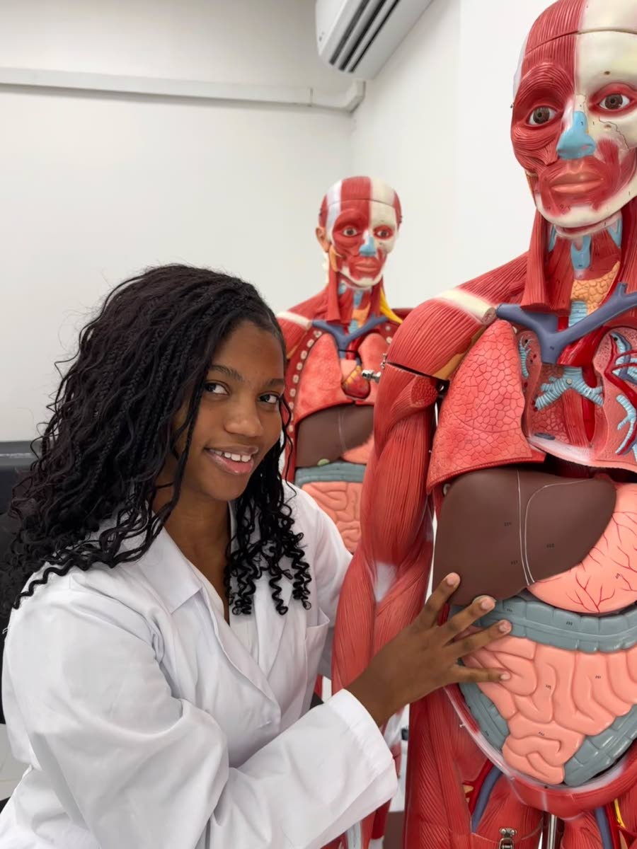 Medical student Tiara Hayles getting ready to check out the anatomy skeleton during one of her classes at the University of Guyana.