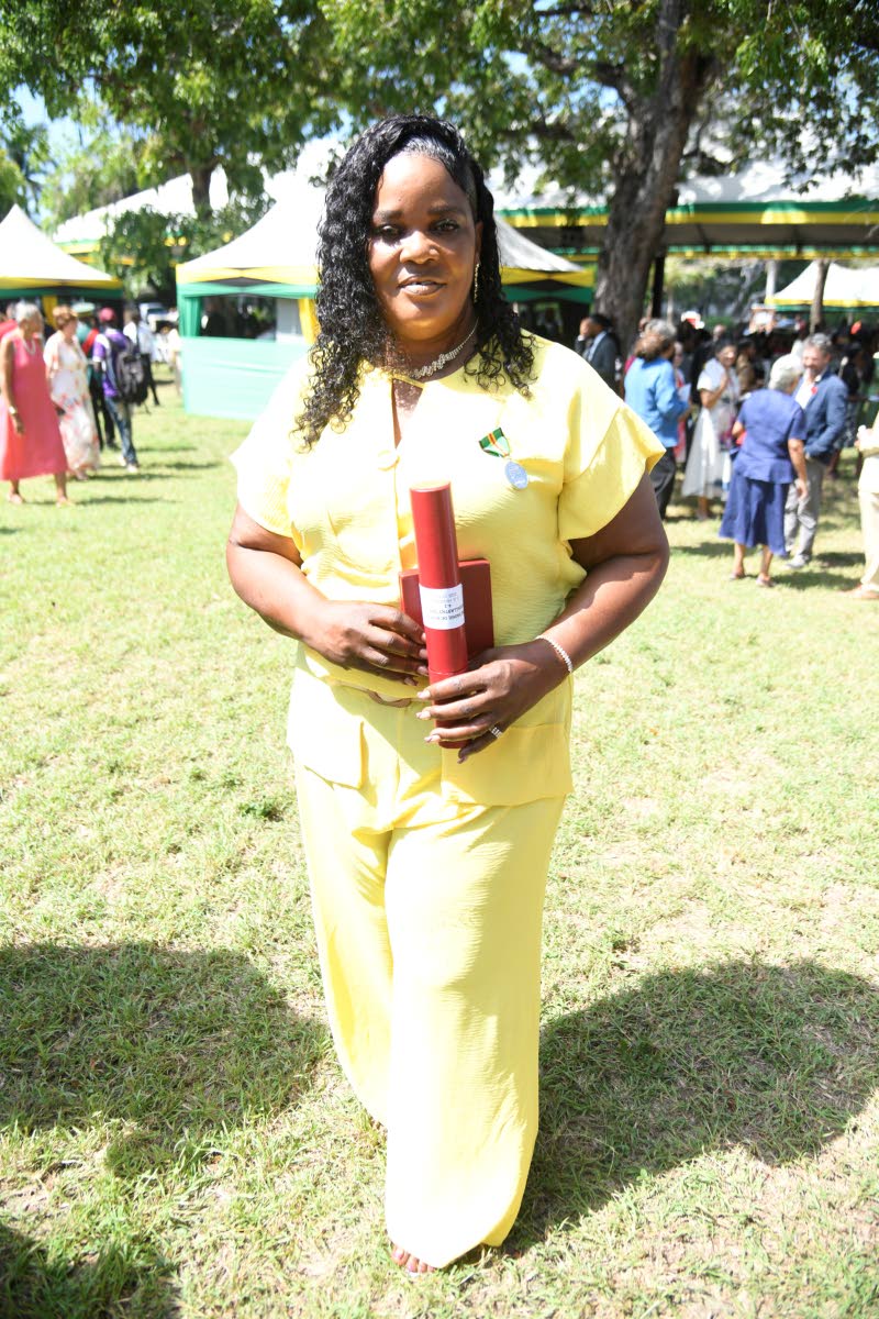 Susan Higgins poses with her Badge of Honour for Gallantry, which she received during the 2026 Ceremony of Investiture and Presentation of National Honours and Awards at King’s House on Monday.