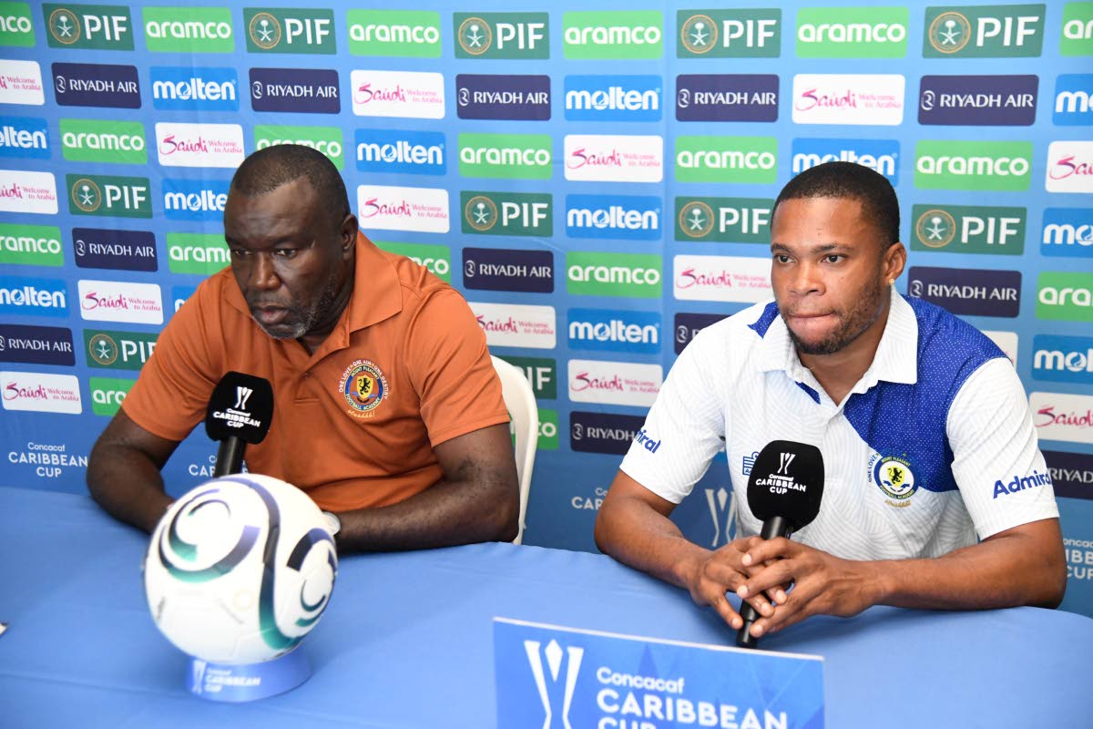 Mount Pleasant head coach Theodore Whitmore (left) and his club captain Sue-Lae McCalla field questions during a press conference yesterday ahead of the team’s Caribbean Cup fixture against Trinidad and Tobago’s Club Sando today at Sabina Park.