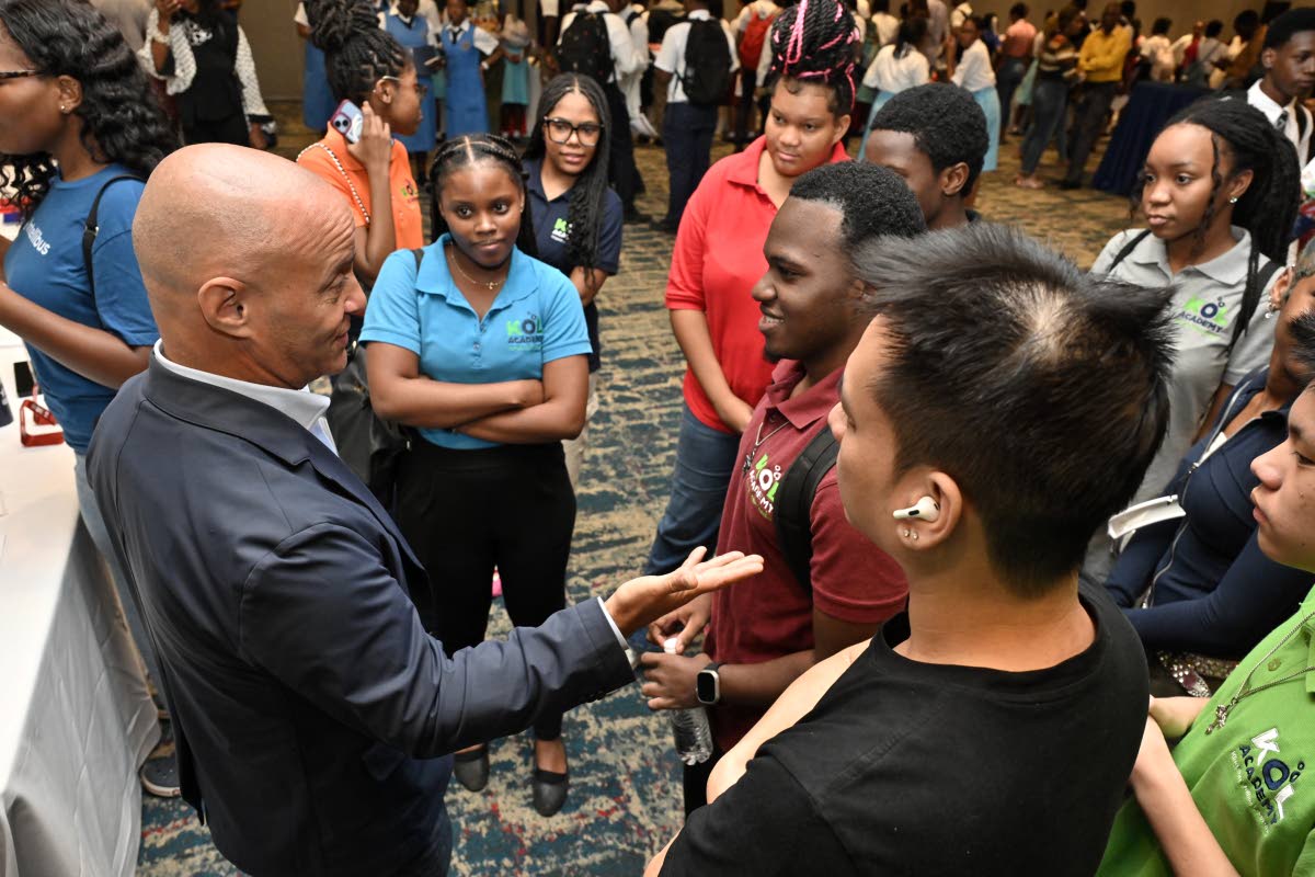 Stefo Lehmann (left), consular officer at the United States (US) Embassy in Kingston, speaks with students about visa requirements, the application process and how to prepare for your US student visa interview, during the EducationUSA College Fair. 