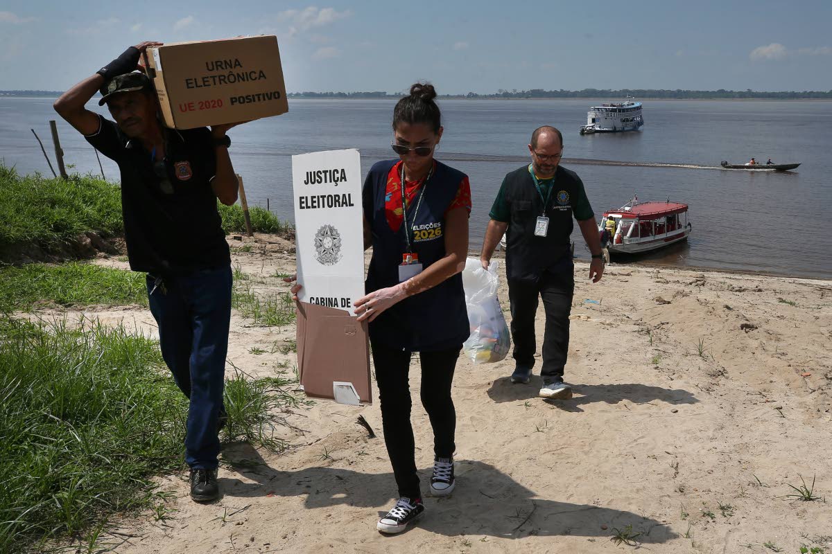 Electoral workers unload electronic voting machines to be taken to a polling station a day ahead of the country’s general elections in the rural riverside community of Costa do Jatuarana, Amazonas state, Brazil on October 3.