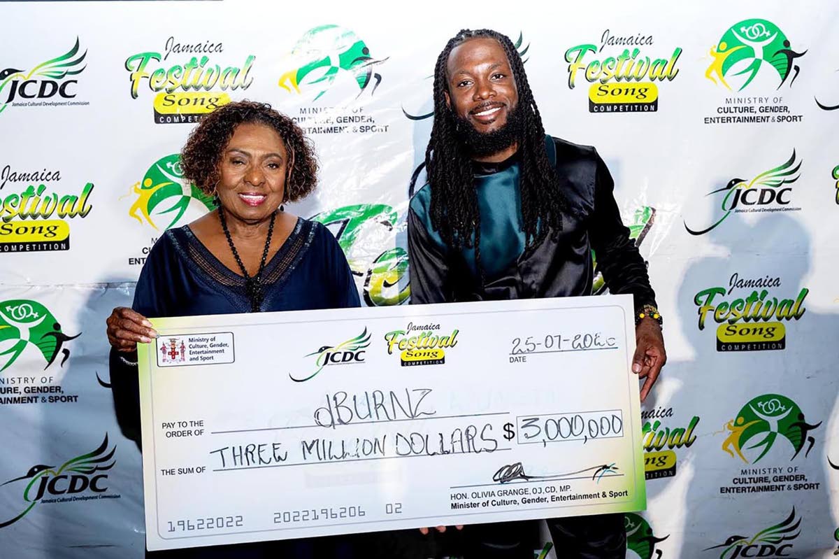 The 2026 Festival Song Competition winner, dBurnz, is presented with one of his prizes by Minister of Culture, Gender, Entertainment and Sport, Olivia Grange.