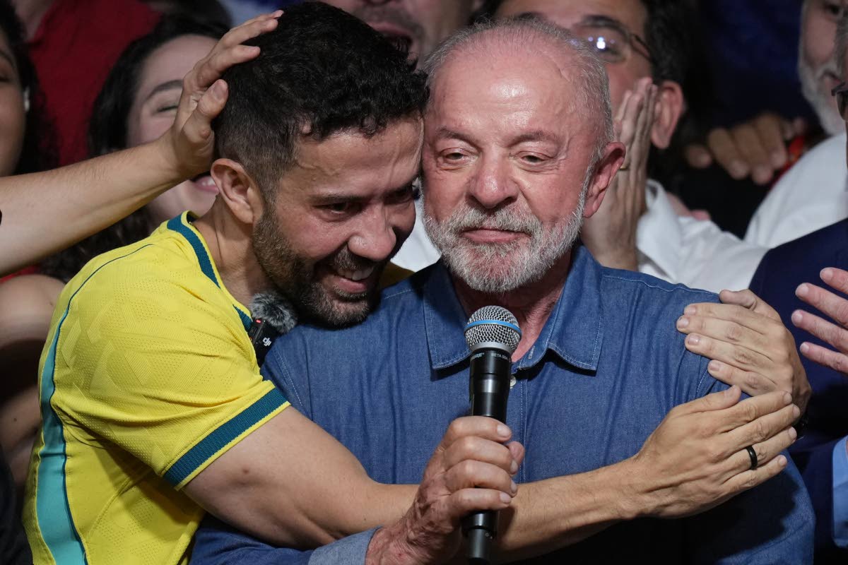 Brazilian lawmaker André Janones embraces President Luiz Inácio Lula da Silva as he delivers a victory speech after winning a fourth term in the presidential runoff in Brazil on Sunday.