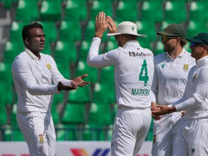 South Africa’s Senuran Muthusamy (left) celebrates with teammates after taking the wicket of Pakistan’s Mohammad Rizwan during the second day of the first Test match in Lahore, Pakistan, yesterday.