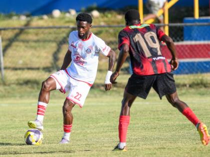 Ronaldo Robinson (left) of Portmore United tries to go around Dexter Manning of Arnett Gardens during their Jamaica Premier League match at Ferdi Neita Park yesterday.