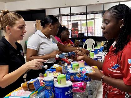 Members of the Stewart’s Automotive Group team pack food, water, and baby essentials into care bundles as the company ramps up relief efforts for families hardest hit by Hurricane Melissa in western Jamaica. 