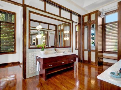 A bathroom featuring opposite his and her basin vanities.