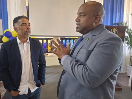 Jason Russell (left), president of the Montego Bay Chamber of Commerce and Industry, and Dwight Crawford, deputy mayor of Montego Bay, in conversation during the University of Technology, Western Jamaica Campus School of Business Administration annual semi