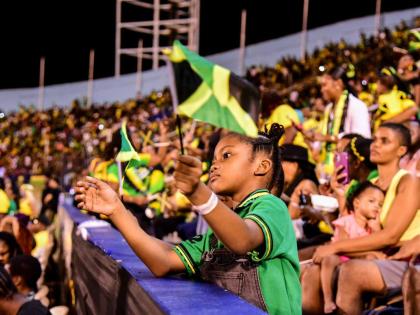 A little girl enjoying the Grand Gala celebrations at the National Stadium. 