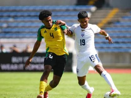 Jamaica's  Dante Plunkett (left) battles for the ball with Raheen
Cuello of Panama during their  Concacaf U-20 Championship Group C match in Puebla, Mexico on Wednesday night. The match ended in a 2-2 draw.