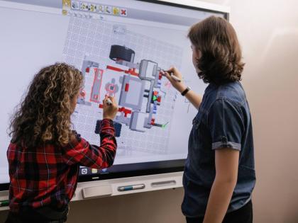 Representational image of students using smartboard in their classroom.