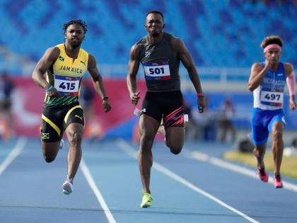 AP Jamaica’s Bouwahjgie Nkrumie (left) and Panama’s Arturo Deliser compete in a men’s 100-metre heat at the Central American and Caribbean Games in Santo Domingo, Dominican Republic, Monday, August 3.