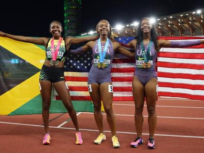From left: Jamaica's Shanoya Douglas and United States twins, Mia and Mariah Maxwell, celebrate the medals they won during the women's 200-metre final at the World Athletics Under-20 Championships at Hayward Field in Eugene, Oregon, yesterday. 